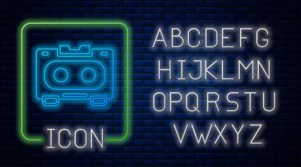 Glowing neon Retro audio cassette tape icon isolated on brick wall background. Neon light alphabet. Vector — Stockvector