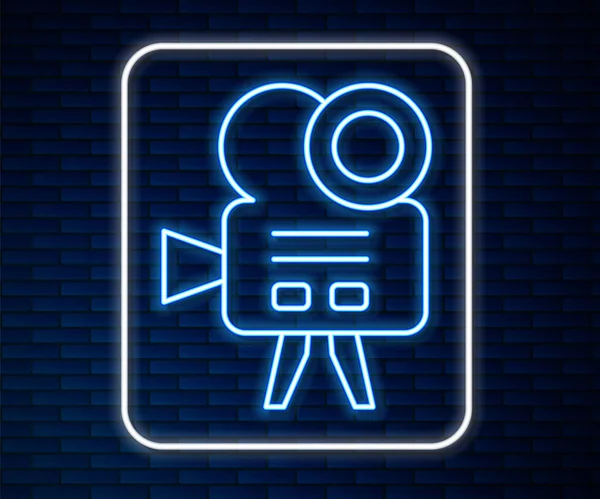 Linea neon incandescente icona della fotocamera cinema retrò isolato su sfondo muro di mattoni. Video camera. Segno cinematografico. Proiettore cinematografico. Vettore — Vettoriale Stock