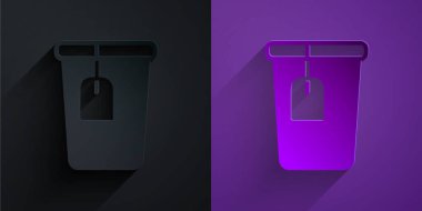 Paper cut Cup with tea bag icon isolated on black on purple background. Paper art style. Vector.