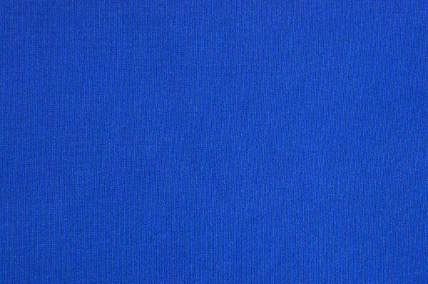 Close-up texture of natural blue fabric or cloth in light blue color. Fabric texture of natural cotton or linen textile material. Blue canvas background.
