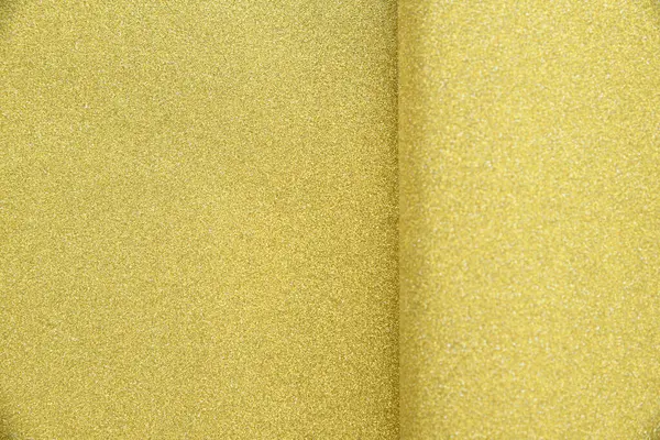 Closeup of luxury gold paper texture selective focus on left and blurry on right. blank space for text
