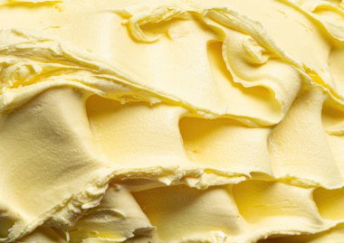 Dondurulmuş ananas aromalı dondurma - tüm çerçeve ayrıntıları. Dondurmanın sarı yüzey dokusunu kapat.