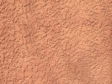 Grunge textured orange plaster texture background.