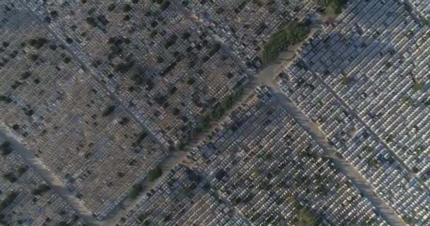 Cemetery graves aerial view above graveyard cemetary with gravestones during day time. Drone passing on textured and pattern shot of graves stones as panoramic landscape — Stock Video