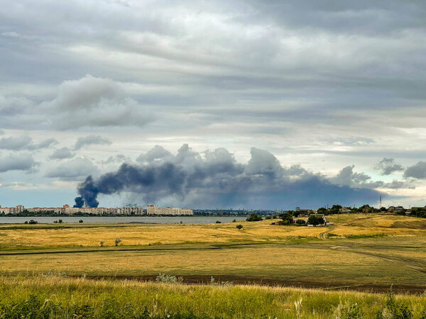 City in smoke after missile attack. Russia's war with Ukraine.
