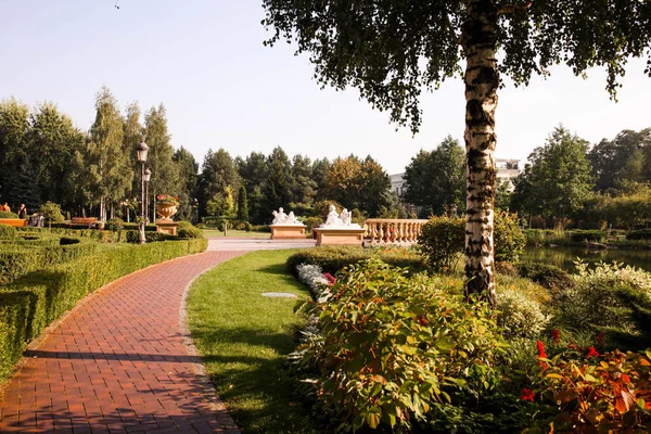 Beautiful landscaping in the estate with flower beds and lake.