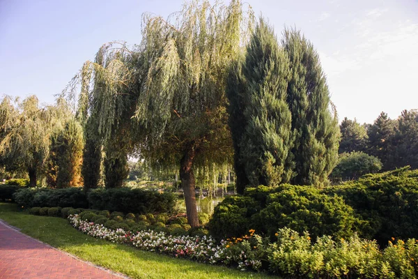 Beautiful landscaping in the estate with flower beds and lake.