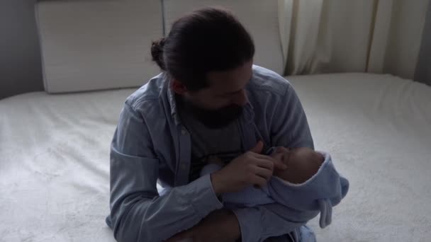 Cinematic Shot Bearded Long-haired Young Neo Father Strokes Face Newborn Baby In Nursery At Home. Dad Holding Infant Child. Children, Parenthood, Childhood, Life, Love, Fatherhood, Family Concept — Stock videók