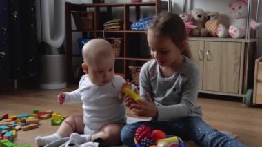 İki Mutlu Kardeşler Oyun Salonundaki Çocuk Kız Çocuğu. Çocuklar Infand ve Anaokulu Ev Yapımı 'nda tahta oyuncaklarla oynuyor. Bebek evde çok zaman geçirdi. Çocukluk, Ebeveynlik, Arkadaşlık Konsepti
