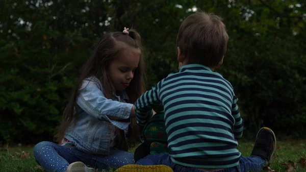 Friends Play Toys Excited Young Children Playing Lying Grass Meadow — стоковое фото