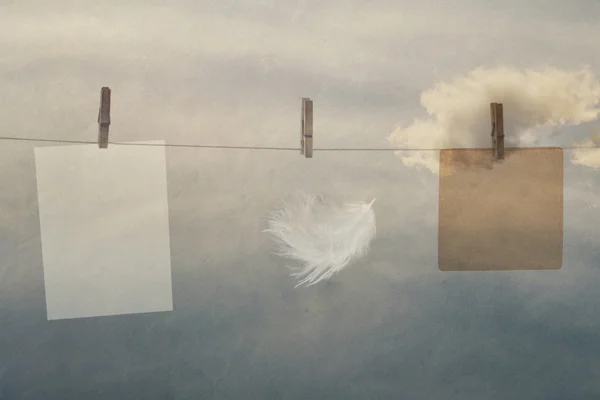 Photo frame from old paper on a rope with clothespins, sky cloud, vintage — Stock Photo, Image