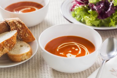 Tomato soup with side salad and crusty bread clipart