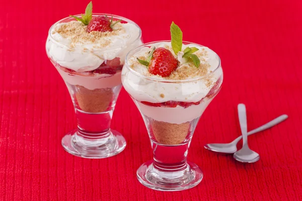 Two strawberry and cream desserts on red background — Stock Photo, Image