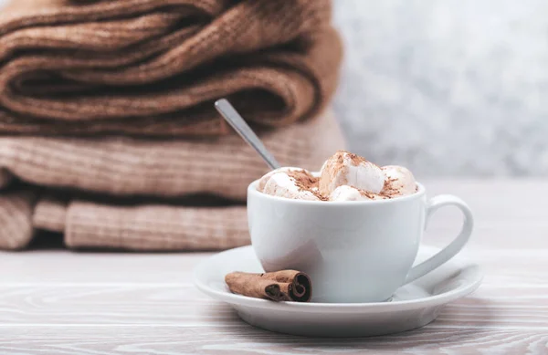 Cup of cacao and pile of knitwear — Stock Photo, Image