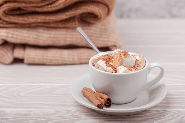 Cup of cacao and pile of knitwear — Stock Photo, Image