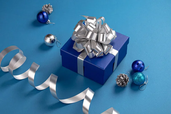Christmas composition with present and decorations in blue and silver colors — Stock Photo, Image