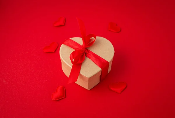 Gift boxes in heart shape with bow on red background, Saint Valentine Day — Stock Photo, Image