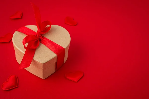 Gift boxe in heart shape with bow on red background, Saint Valentine Day — Stock Photo, Image