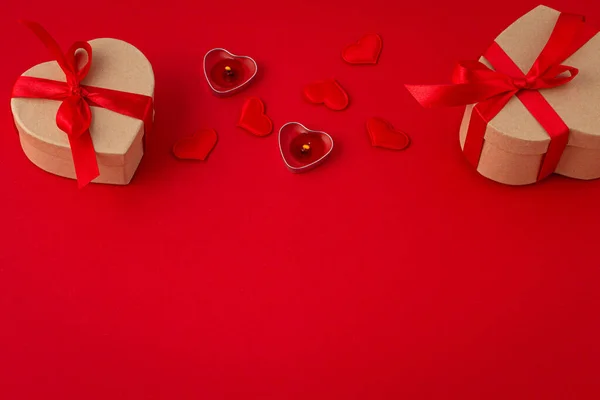 Saint Valentine top view composition with gift box, candles, hearts on red background — Stock Photo, Image