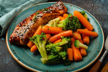 Close-up of delicious grilled salmon fillet steak in teriyaki sauce with roasted vegetables clipart