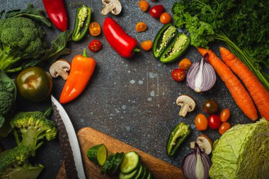 Food cooking background with assorted fresh vegetables on rustic concrete table