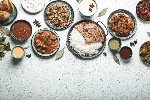 Indian ethnic food buffet on white concrete table top view copy space