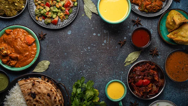 Indian ethnic food buffet on concrete table from above copy space