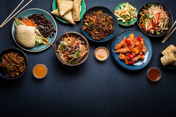 Set of Chinese dishes on table space for text — Stock Photo, Image