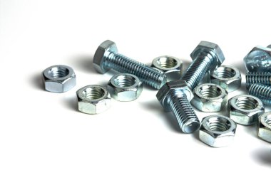Various silver metal bolts. Fastening bolts with washers and nuts on a white background close-up. Copy space.