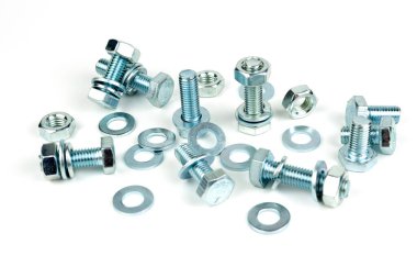 A large group of silver fasteners for fastening structures. Bolts and nuts with washers close-up on a white background.