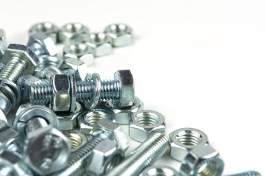 Various silver metal bolts. Fastening bolts with washers and nuts on a white background close-up. Copy space.
