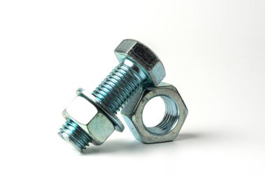 large bolt made of silver metal. Bolts, nuts and washers on a white background close up