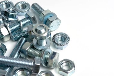 several bolts with nuts made of silver metal. Close-up isolated on a white background. Copy space