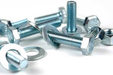 Metal cıvatalar ve fındıklar. Yuvarlak temizleyiciler beyaz arka planda.