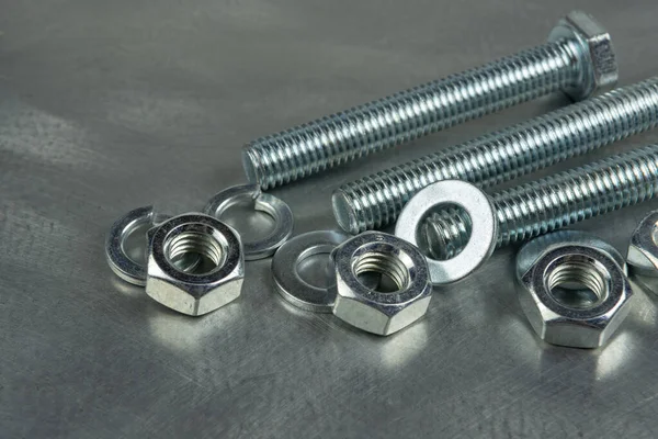 Bağlantıları birleştirmek için Fasteners. Fındık ve cıvatalar. Metal bir boşluğun arka planına yakın plan. Boşluğu kopyala