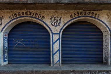 Closed shop in Angahuan with shuttered blue gates