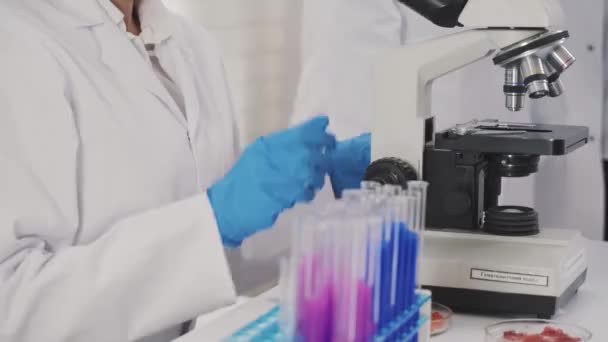 Medical Development Laboratory: Looking Under Microscope, Analyzes Sample — Stock Video