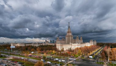 Moskova, Rusya - 30 Ekim 2020: Sonbaharda dramatik bulutlu gökyüzü altında Moskova Üniversitesi 'nin günbatımı kampüs binalarının hava panoramik manzarası