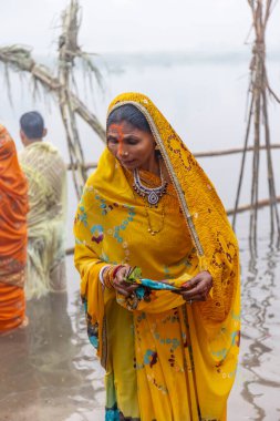 Ghaziabad, Uttar Pradesh, India - November 2021: Chhath Puja, Indian hindu devotees performing rituals of chhath puja in the night near river bank.