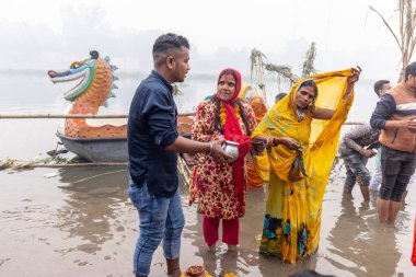 Ghaziabad, Uttar Pradesh, India - November 2021: Chhath Puja, Indian hindu devotees performing rituals of chhath puja in the night near river bank.