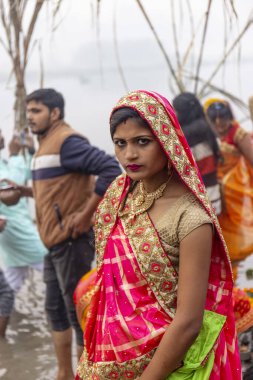 Ghaziabad, Uttar Pradesh, India - November 2021: Chhath Puja, Indian hindu devotees performing rituals of chhath puja in the night near river bank.