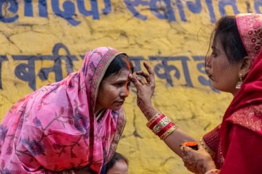 Ghaziabad, Uttar Pradesh, India - November 2021: Chhath Puja, Indian hindu devotees performing rituals of chhath puja in the night near river bank.