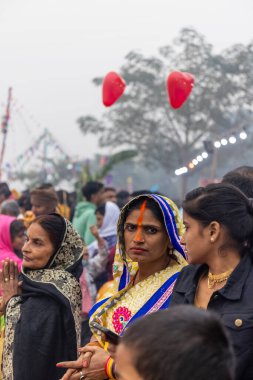 Ghaziabad, Uttar Pradesh, India - November 2021: Chhath Puja, Indian hindu devotees performing rituals of chhath puja in the night near river bank.