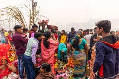 Ghaziabad, Uttar Pradesh, India - November 2021: Chhath Puja, Indian hindu devotees performing rituals of chhath puja in the night near river bank.