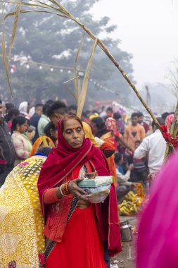 Ghaziabad, Uttar Pradesh, India - November 2021: Chhath Puja, Indian hindu devotees performing rituals of chhath puja in the night near river bank.