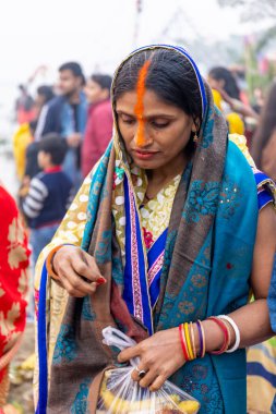 Ghaziabad, Uttar Pradesh, India - November 2021: Chhath Puja, Indian hindu devotees performing rituals of chhath puja in the night near river bank.