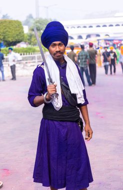 Anandpur Sahib, Punjab, India - March 2022: Portrait of sikh male (Nihang Sardar) during the celebration of Hola Mohalla at Anandpur Sahib on holi festival.