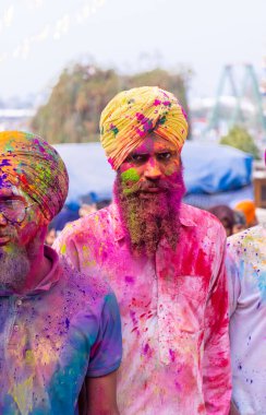 Anandpur Sahib, Punjab, India - March 2022: Celebration of Hola Mohalla at Anandpur Sahib during holi festival. Selective focus on colorful face.