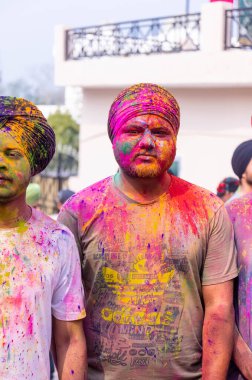 Anandpur Sahib, Punjab, India - March 2022: Celebration of Hola Mohalla at Anandpur Sahib during holi festival. Selective focus on colorful face.