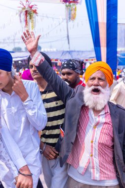 Anandpur Sahib, Punjab, Hindistan - Mart 2022: Holi festivali sırasında Hola Mohalla 'nın Anandpur Sahib' de kutlanması. Renkli yüze seçici odaklanma.